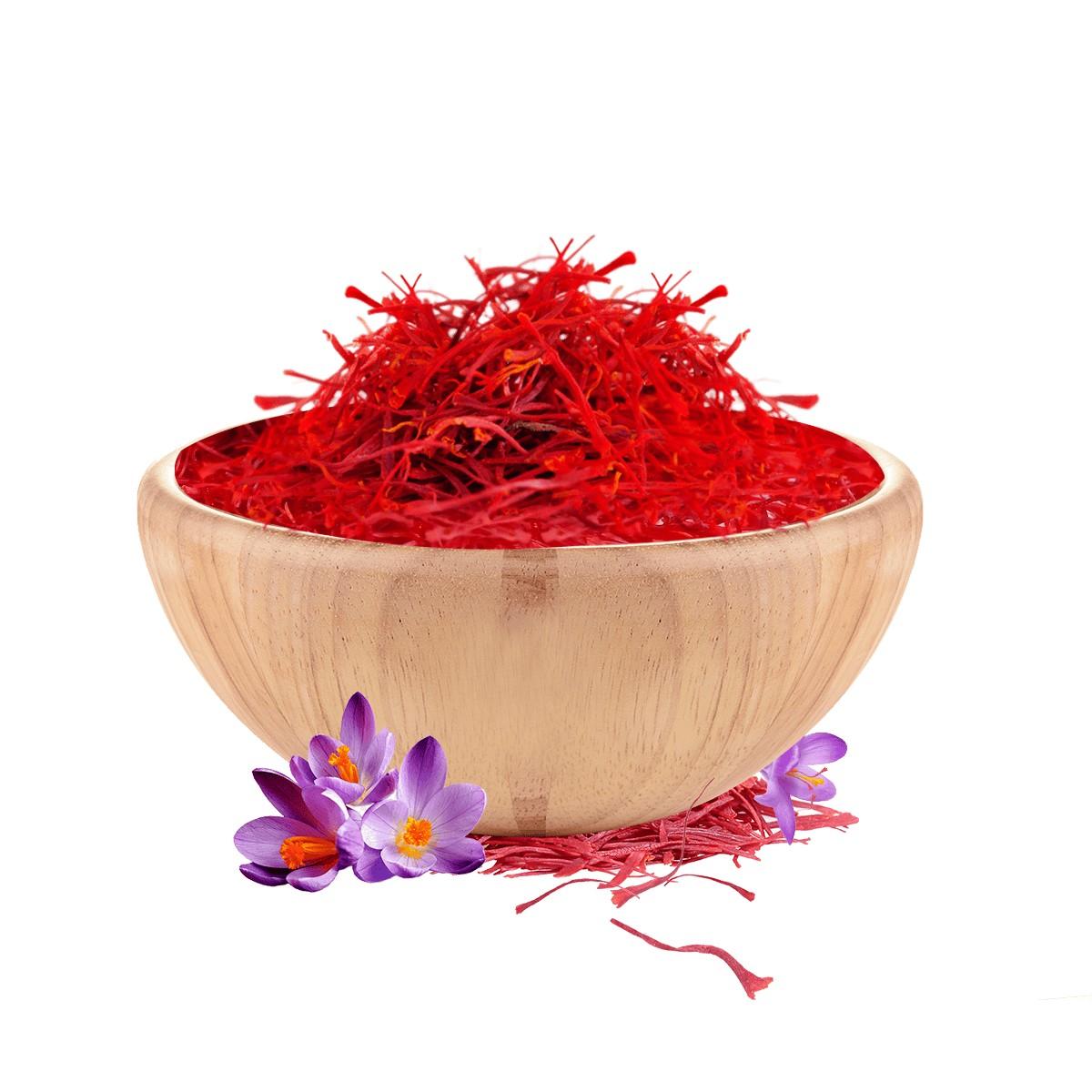 Red saffron in a wooden bowl with saffron flowers on a white background